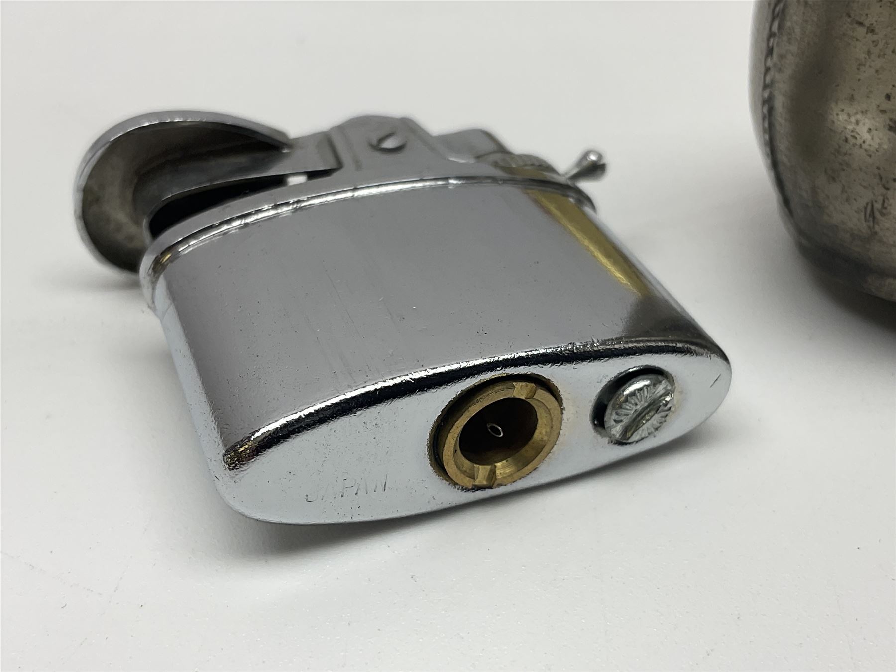 Ronson gilt metal table lighter, together with a silver-plate table lighter in the form of a football boot