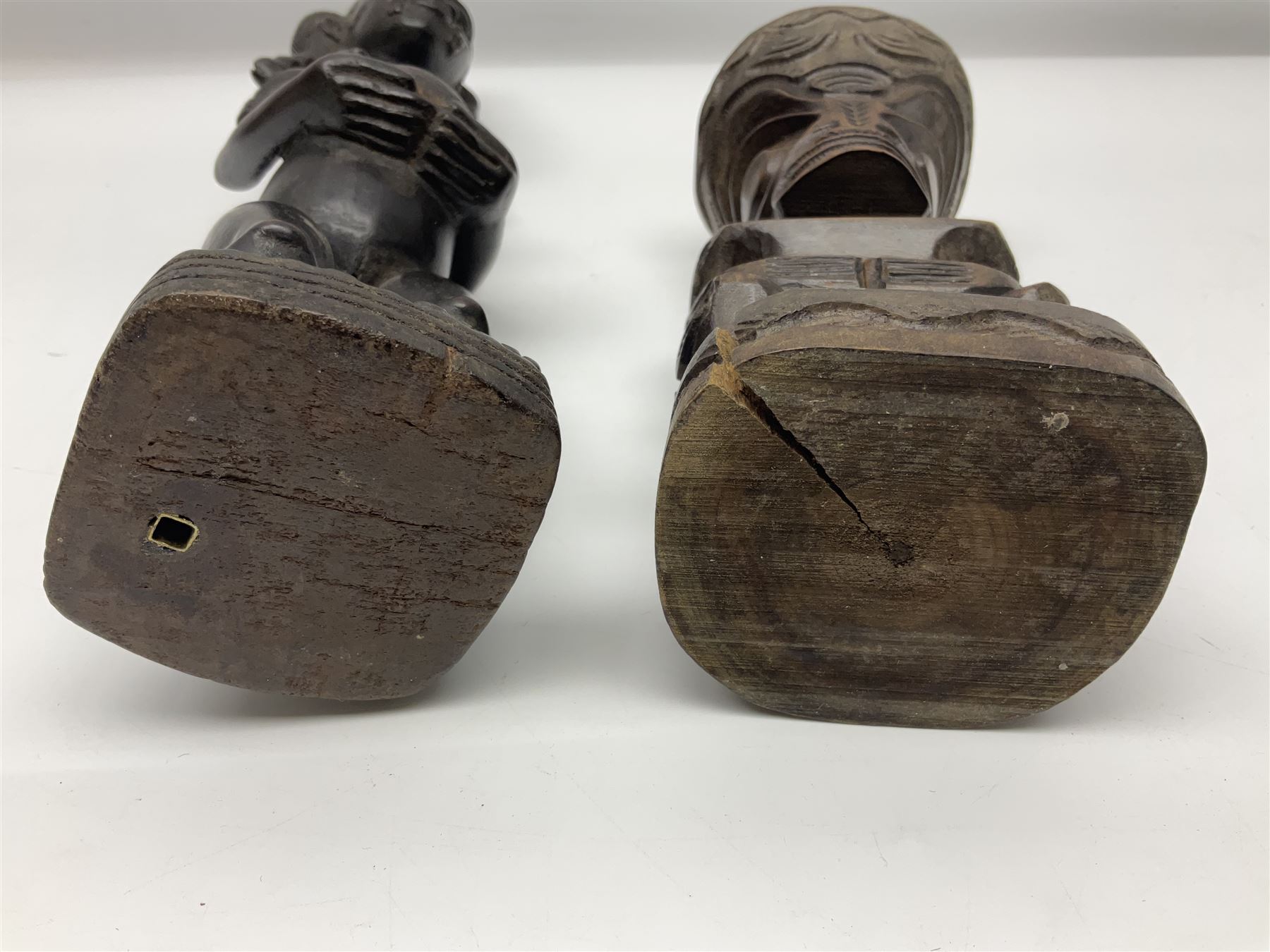 Carved african figures, together with a polynesian figure, largest H38cm