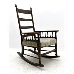 William Birch for Liberty & Co. - Arts and Crafts period oak ladder back rocking chair, the arms supported by a series of turned spindles, upholstered seat