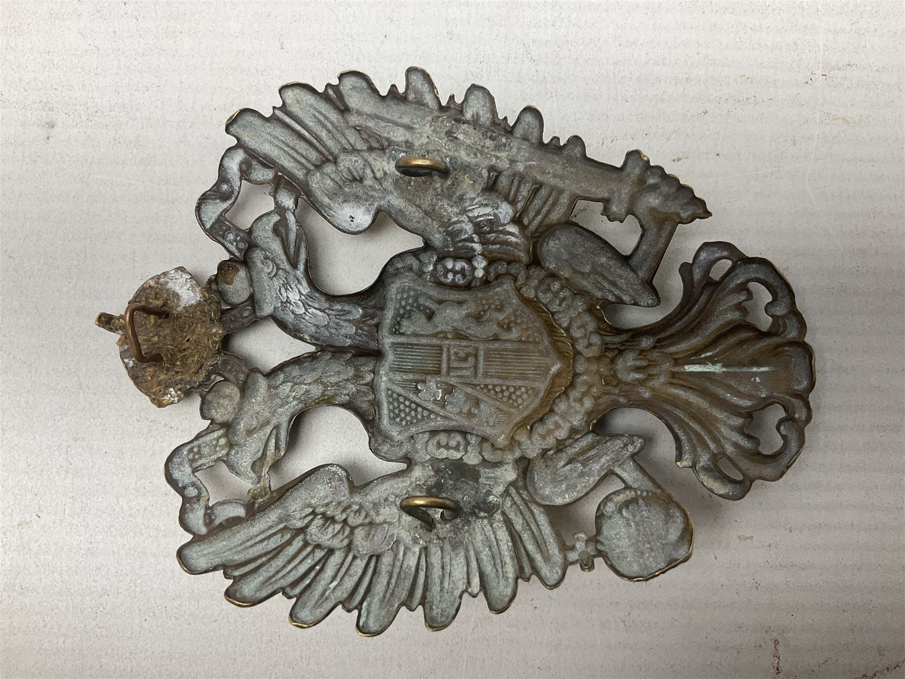 Austrian shako plate 1890 - 1914 with three fixing eyes verso