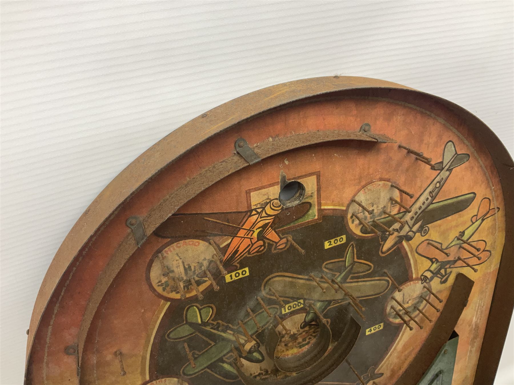 1934 Lindstrom's 'Airways' tin-plate bagatelle game by Lindstrom Tool and Toy Company Bridgeport Conn., the decorative bagatelle board depicting Lindstrom's epic airway routes; with wooden peg and quantity of balls H61cm