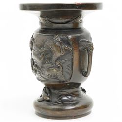 Chinese 20th century polished bronze rice pot with swing handle and raised pattern of dragons D18cm, Meiji period Japanese bronze two handled vase H13cm and a Chinese porcelain bowl from the Tek Sing cargo D15cm (3)