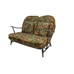 Ercol - dark elm and beech two seater sofa, with loose floral cushions