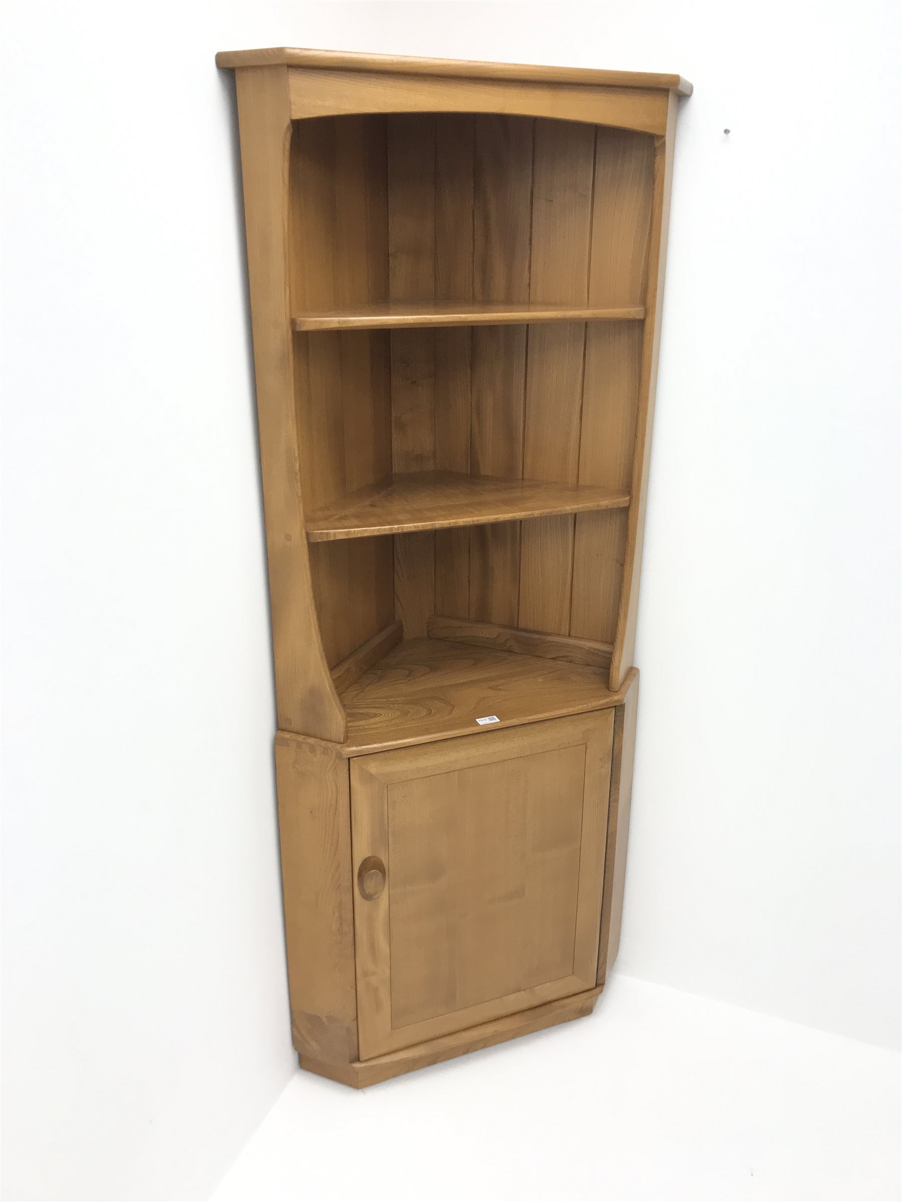 ercol light elm corner two fixed shelves above single cupboard