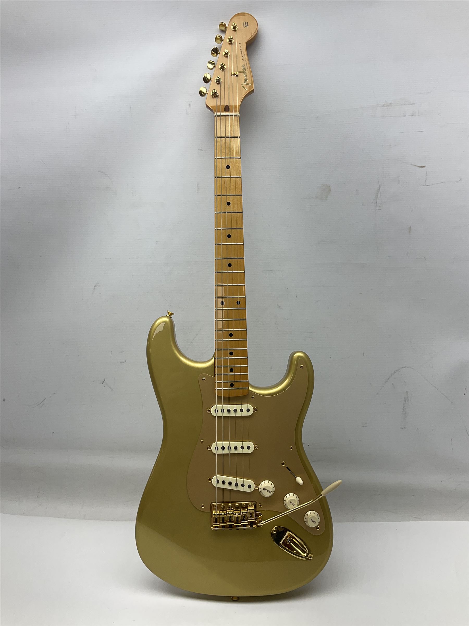 Fender Stratocaster 50th Anniversary 2004 metallic gold electric guitar; serial no.MZ4116369; L98cm; in Spider fitted case with owners manual and other paperwork, strap and belt buckle etc