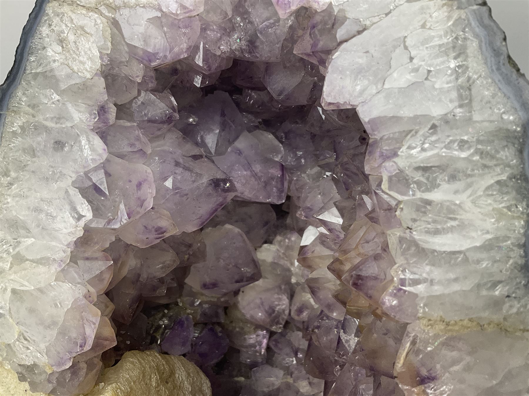 Amethyst crystal ‘cathedral’ geode, free standing with flat base and prepared outer surface, with well-defined crystals of various sizes within the cavern, H39, L32cm