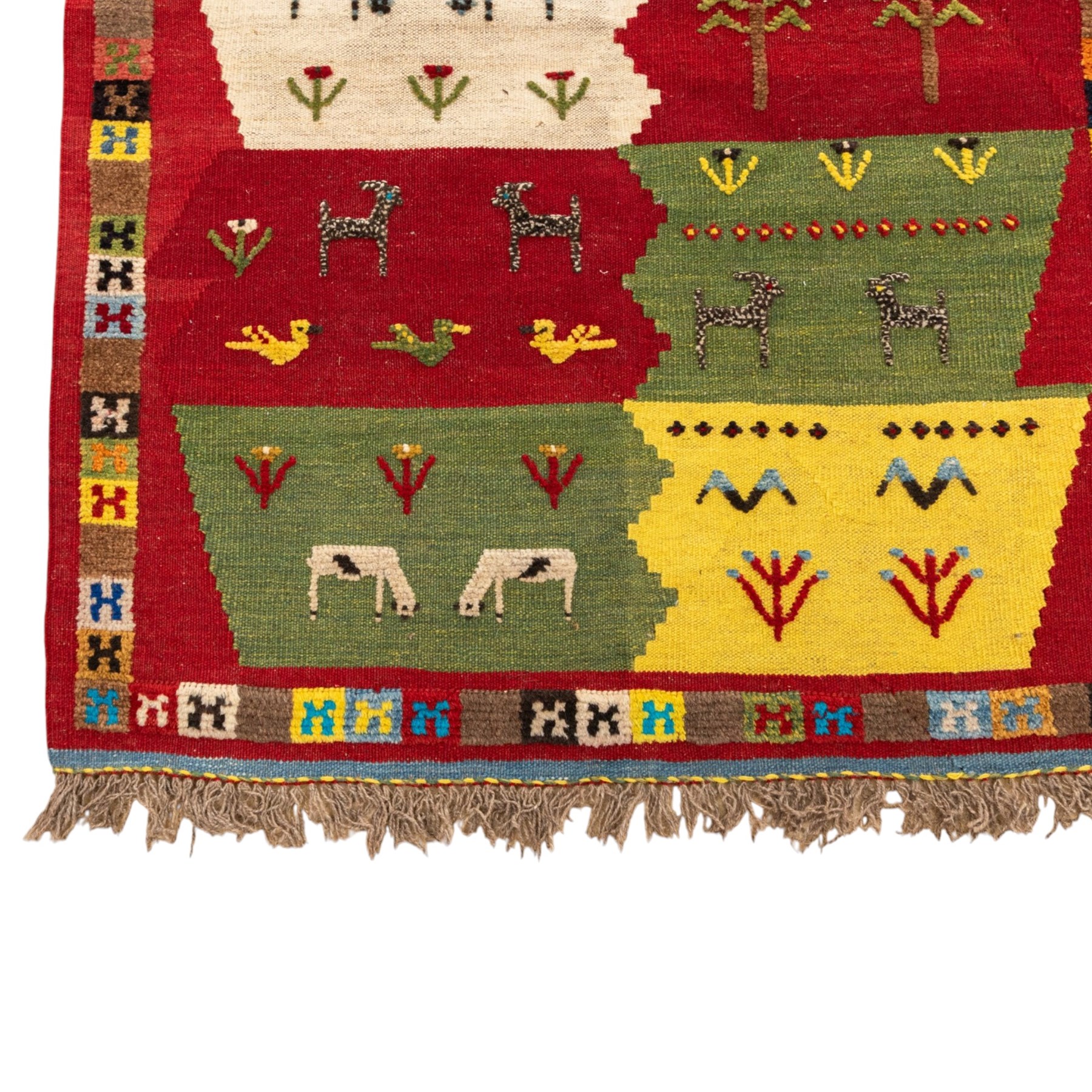 South West Persian Qashqai kilim, the field arranged with stepped polychrome panels depicting stylised camels, goats, cattle and birds, interspersed with trees and flowering stems, enclosed by a red border with multicoloured geometric devices