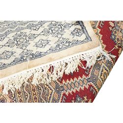 Jaldar Bokhara crimson and pale ground carpet, the field decorated with five rows of Gul motifs, within intricate multi-band border decorated with repeating geometric designs 