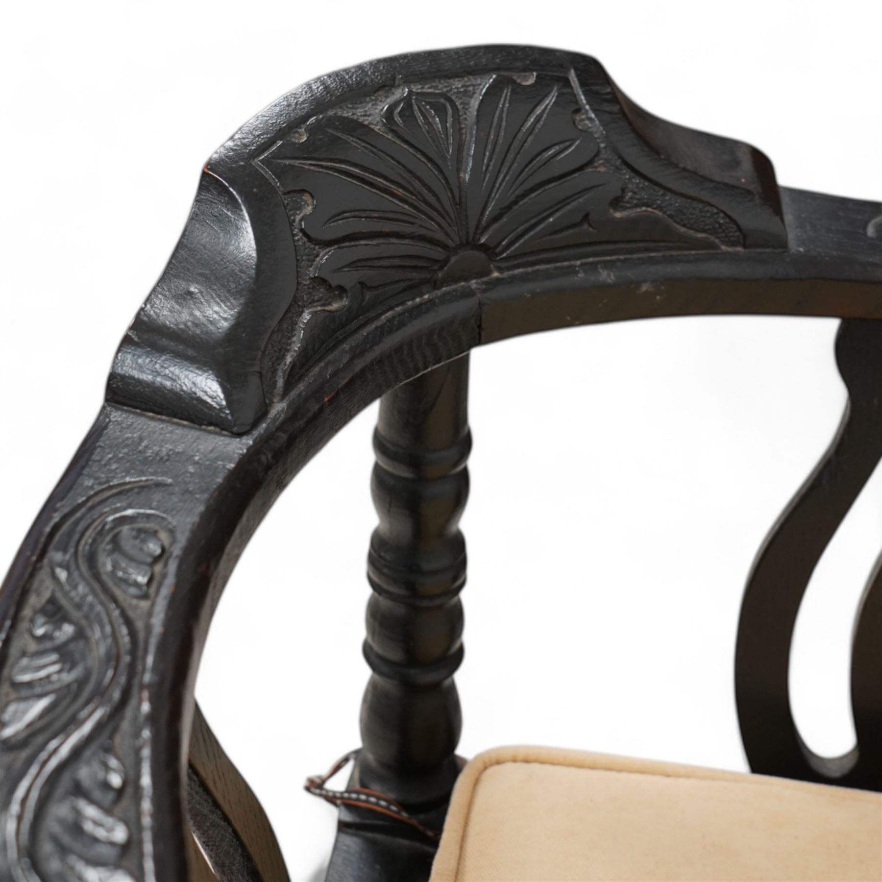 Victorian carved oak corner chair, shaped arms carved with trailing leafy branches, pierced splats over panelled seat, on bobbin turned supports and stretcher