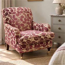 Traditional Howard shape armchair, rolled back and arms over deep seat, raised on turned s...