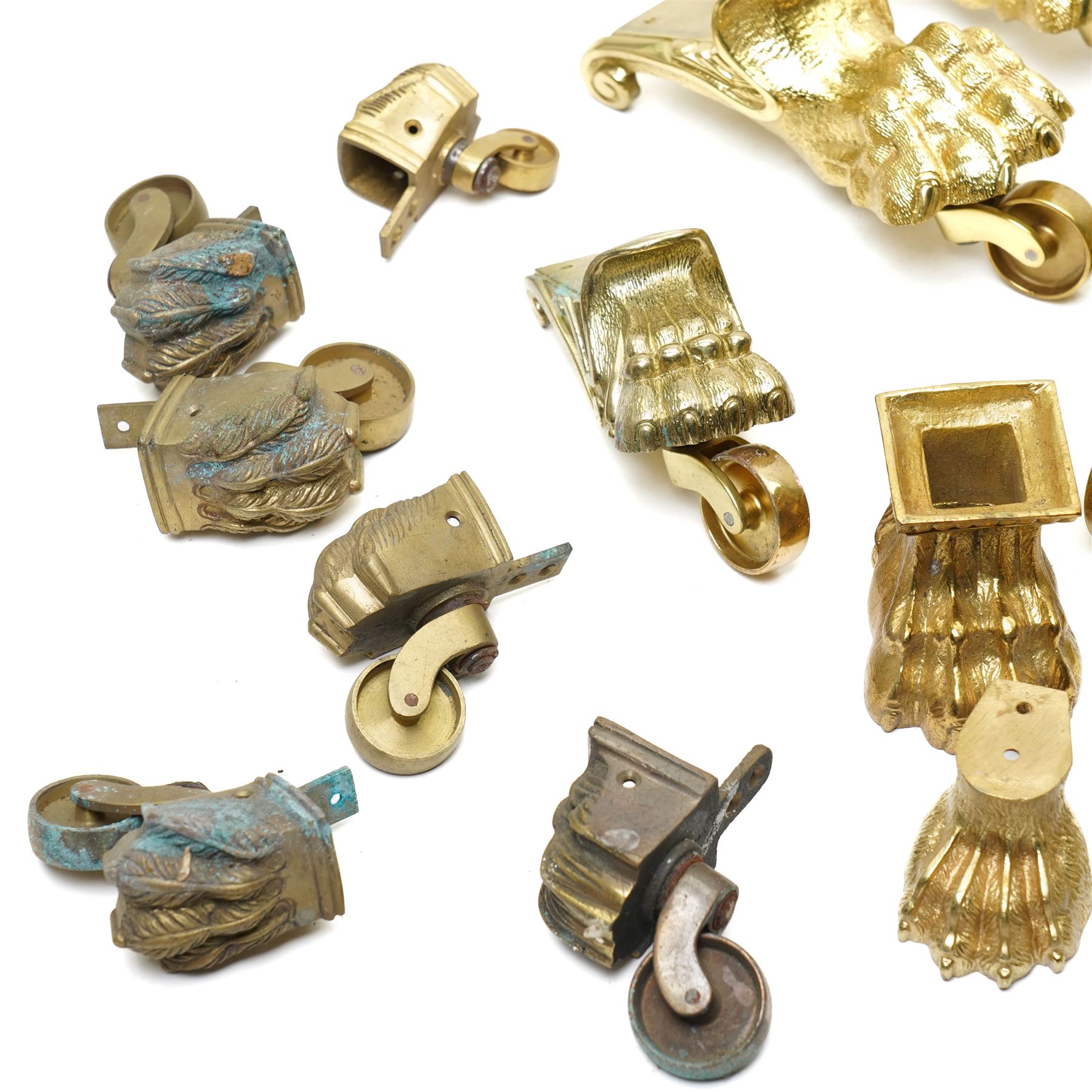 Set of four period design lacquered brass paw furniture castors by Beardmore, London, set of four matching smaller castors and a quantity of various brass castors   
Provenance: property of a Nobleman