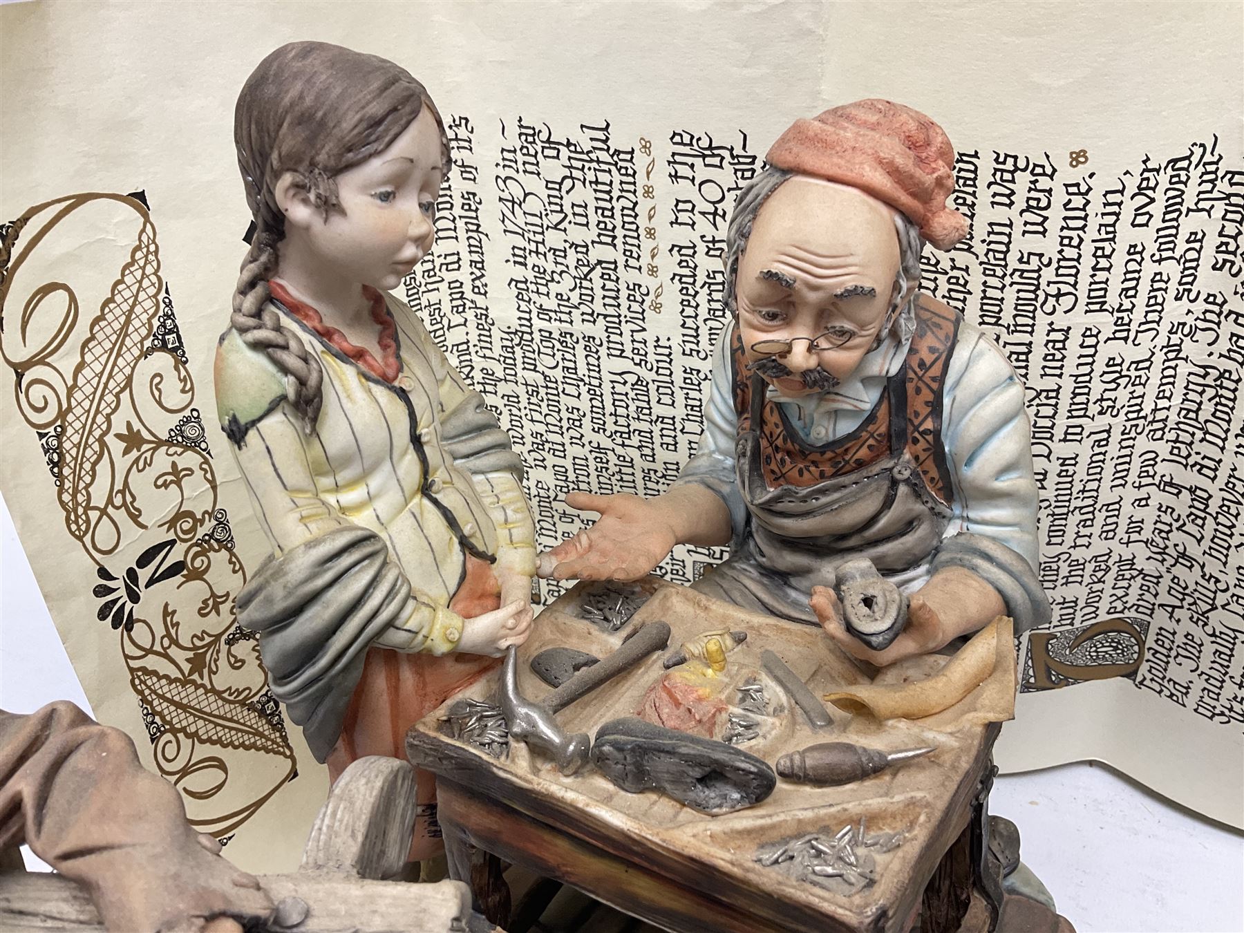 Four Capodimonte figure groups, to include tramp figures, shoemaker figure etc