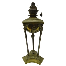  19th century French Neoclassical style brass oil lamp, decorated with three figural winged masks, the reservoir applied with acanthus leaf and pinecone terminal, on three lion paw feet, H33cm   
