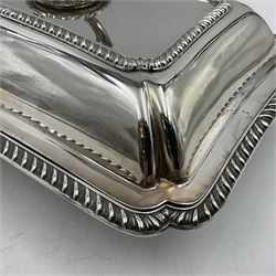 Early 20th century silver entree dish and cover, of rectangular form with shaped corners and oblique gadrooned borders to base and cover, the cover with loop 'bamboo' handle, hallmarked Thomas Bradbury & Sons Ltd, Sheffield 1930, including handle H10.5cm L24.5cm