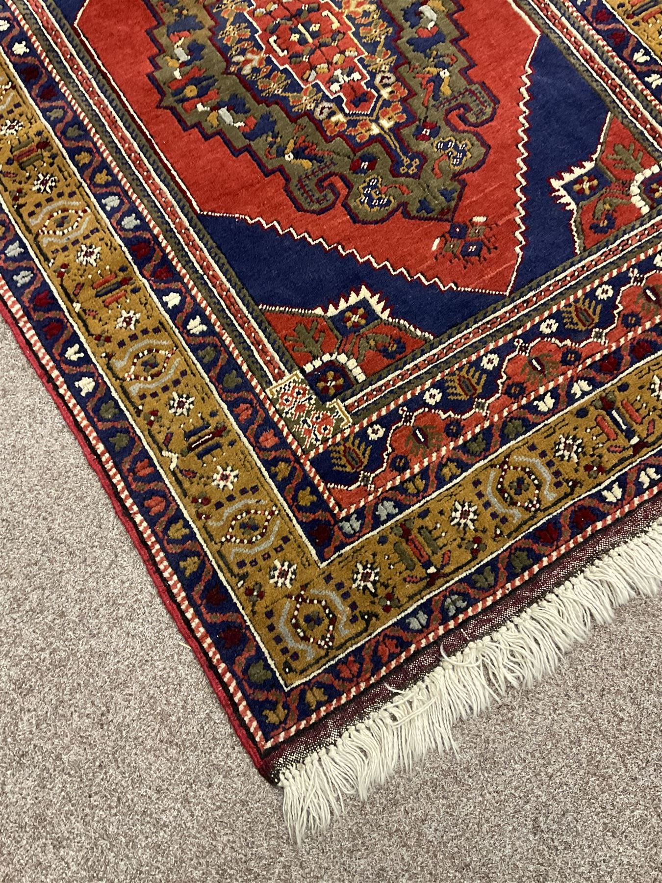 Turkish Taspinar rug, blue ground with central lozenge and medallion, the outer borders decorated with stylised motifs