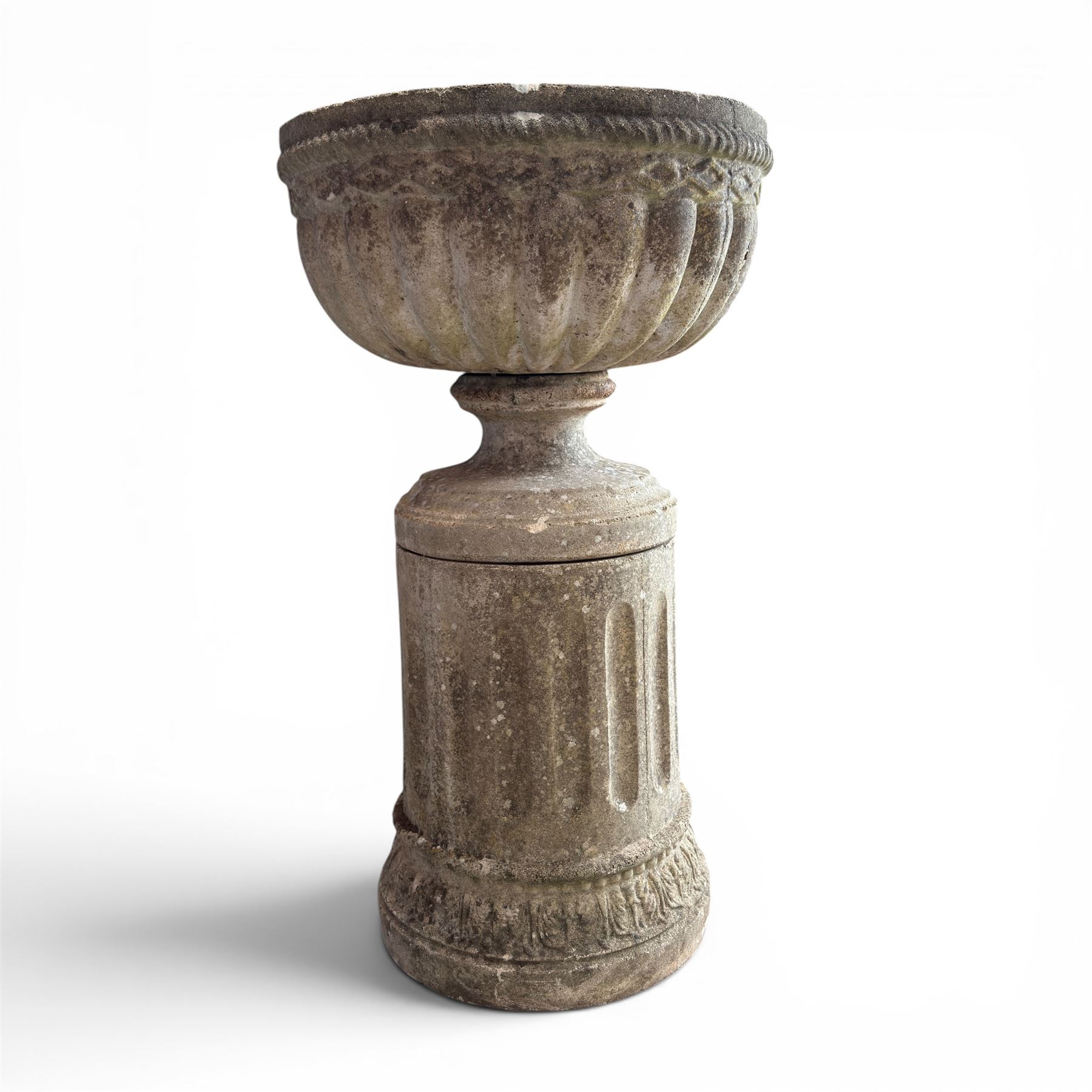 20th century good quality weathered cast stone pedestal urn of ecclesiastical design, circular lobed bowl with rope twist and lattice border, raised on squat base with fluted column  and acanthus decorated base