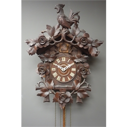  Early 20th century Black Forest style cuckoo clock, with cockrill pediment, carved with flower heads and foliage, H56cm   