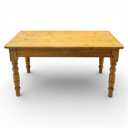 Late 20th century pine farmhouse dining table and four chairs, the rectangular plank top with rounded corners over two frieze drawers fitted with turned knob handles, raised on turned legs, the chairs with shaped ladder backs and turned finials, rush seats in a herringbone weave, on turned supports united by stretchers