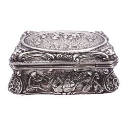 Late 19th century German Hanau silver box, of shaped rectangular form, embossed throughout, the hinged cover decorated with a central oval panel depicting a genre scene with musicians, the corners detailed with masks, the sides detailed with conforming figures and musical trophies, opening to reveal a gilt interior, with Hanau marks for Neresheimer & Sohne, and hallmarked B Muller & Son, London import 1907, approximate weight 3.32 ozt (103.4 grams)