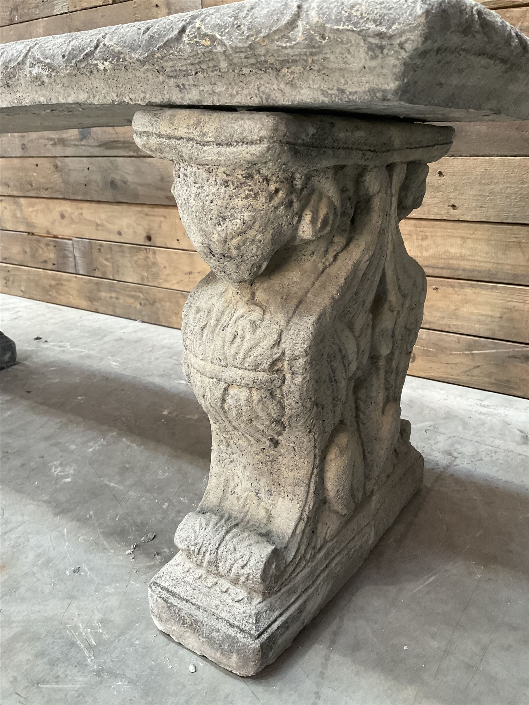 Cast stone garden Rams Head bench, two pillars set with architectural rams heads, rectangular slab seat