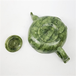 A carved jade teapot, the spout modelled as the head of a bird, the handle modelled as a stylised dragons head, H7.5cm. 