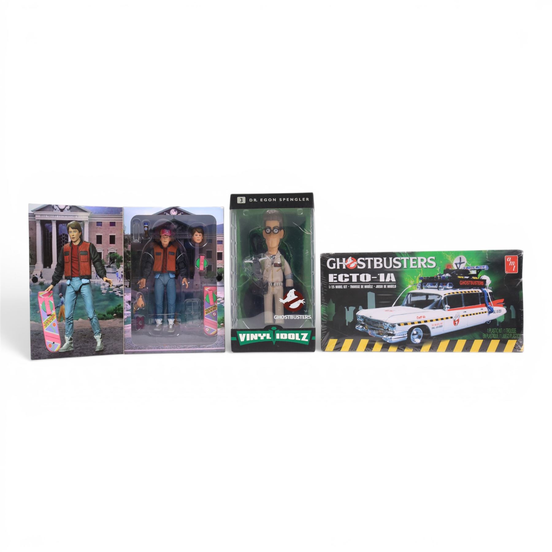Neca Back to the Future Marty Mcfly figure, AMT Ghostbusters Ecto-1A 1:25 scale model kit and Vinyl Idolz Egon Spengler figure, all boxed