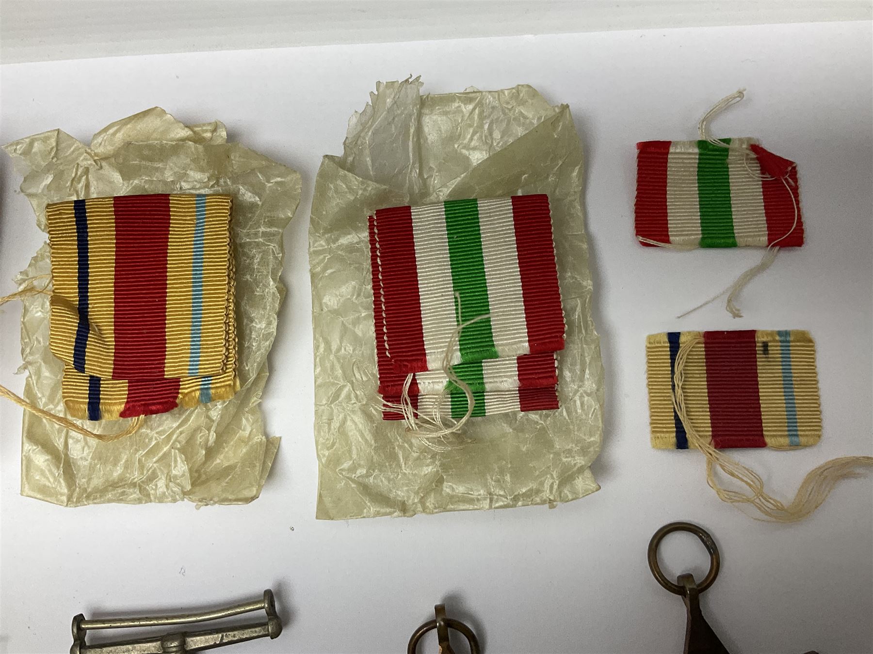 WWII group of three medals comprising 1939-45 War Medal and Italy and Africa Stars in issue box; dog tags for 282894 W. Wilkinson with framed photograph in uniform; and small quantity of cloth and metal badges including RAOC cap badge