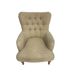 Traditional wingback armchair, upholstered in buttoned fabric with sprung seat, raised on turned supports