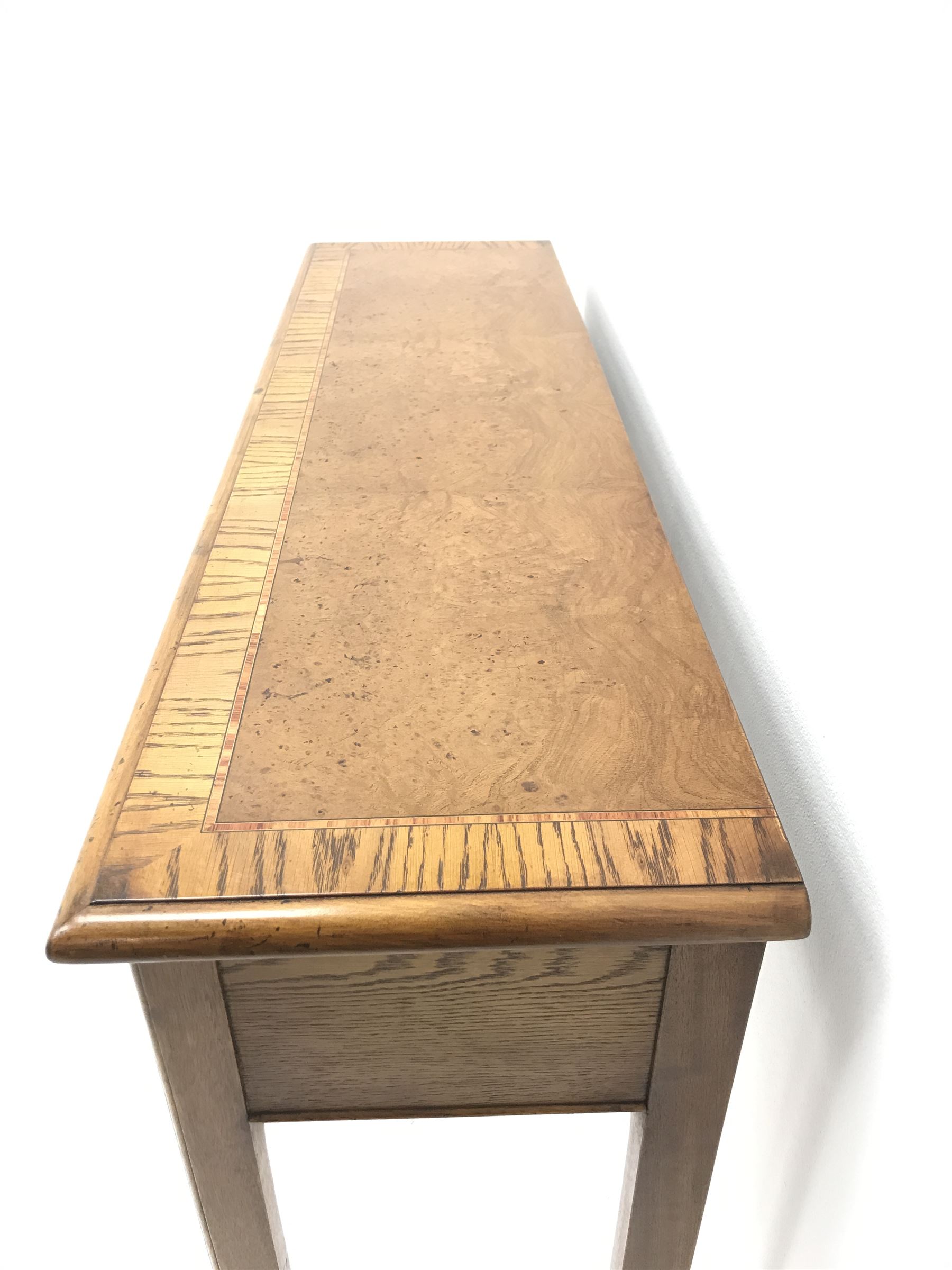 Contemporary oak, mahogany, and figured burr walnut narrow console table, moulded rectangular top with oak band and satinwood stringing, five cock beeded short drawers with turned handles, moulded and canted square supports 