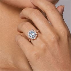 18ct white gold aquamarine and diamond cluster ring, single oval cut aquamarine of approx 0.85 carat, surrounded by twelve round brilliant cut diamonds, hallmarked, total diamond weight approx 0.50 carat