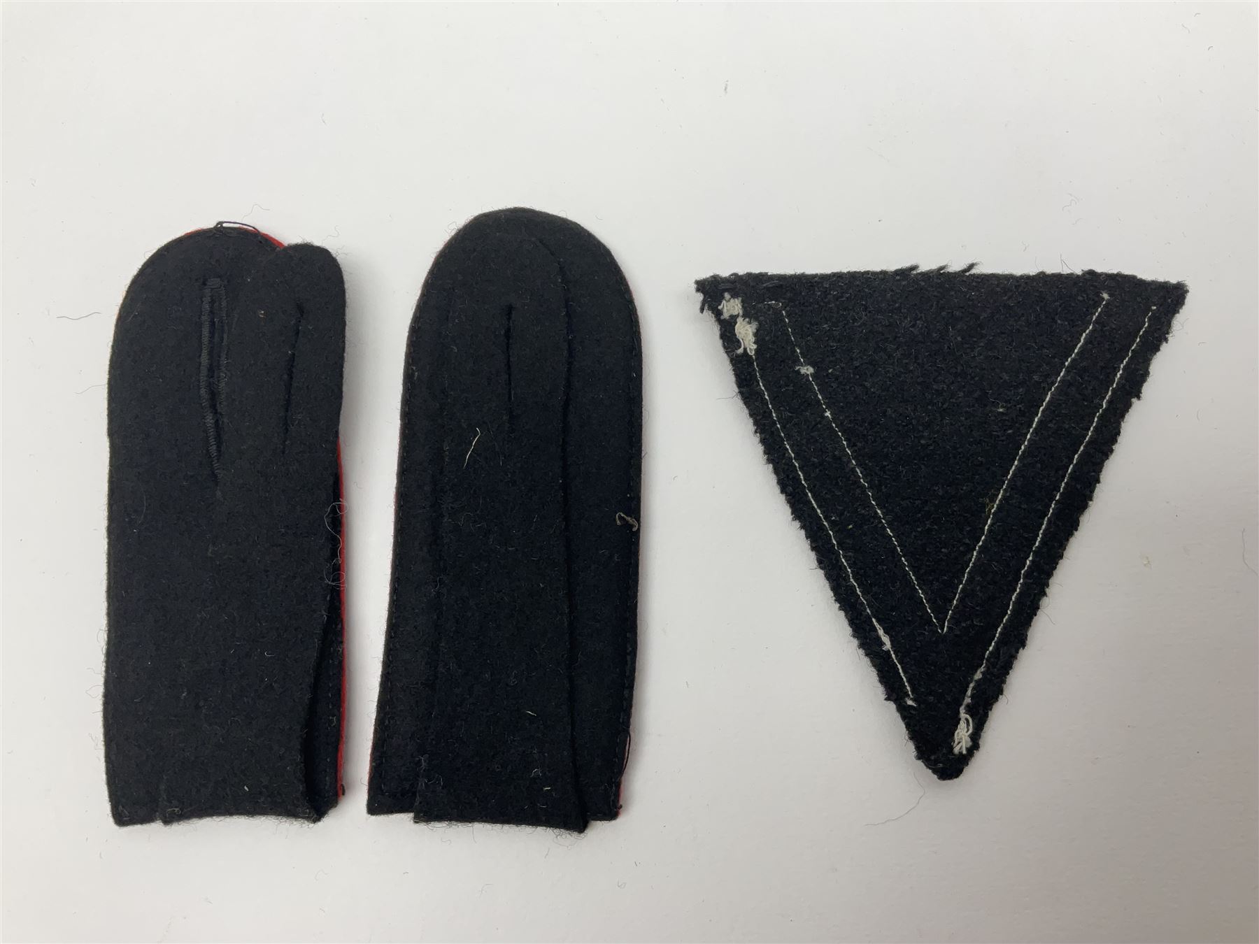 Collection of eleven German metal and cloth badges and uniform buttons including driver's badge, two 'SS' fabric skulls, private's shoulder tabs, Police cloth badge, tank destruction badge, medal bars and ribbon etc; most WW2 period