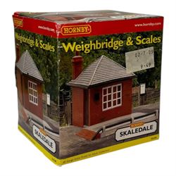 Ten Hornby '00' gauge Skaledale buildings, comprising two R8744 Straight Walls, R8564 Model Shop, R9768 The Pharmacy, R8501 Raven Cottage, R8515 Clovelly Cottage, R8626 Country Fire Station, R8588 Weighbridge & Scales, R8638 Platform & Shelter and R9763 Off Your Head Barbers Shop, all boxed