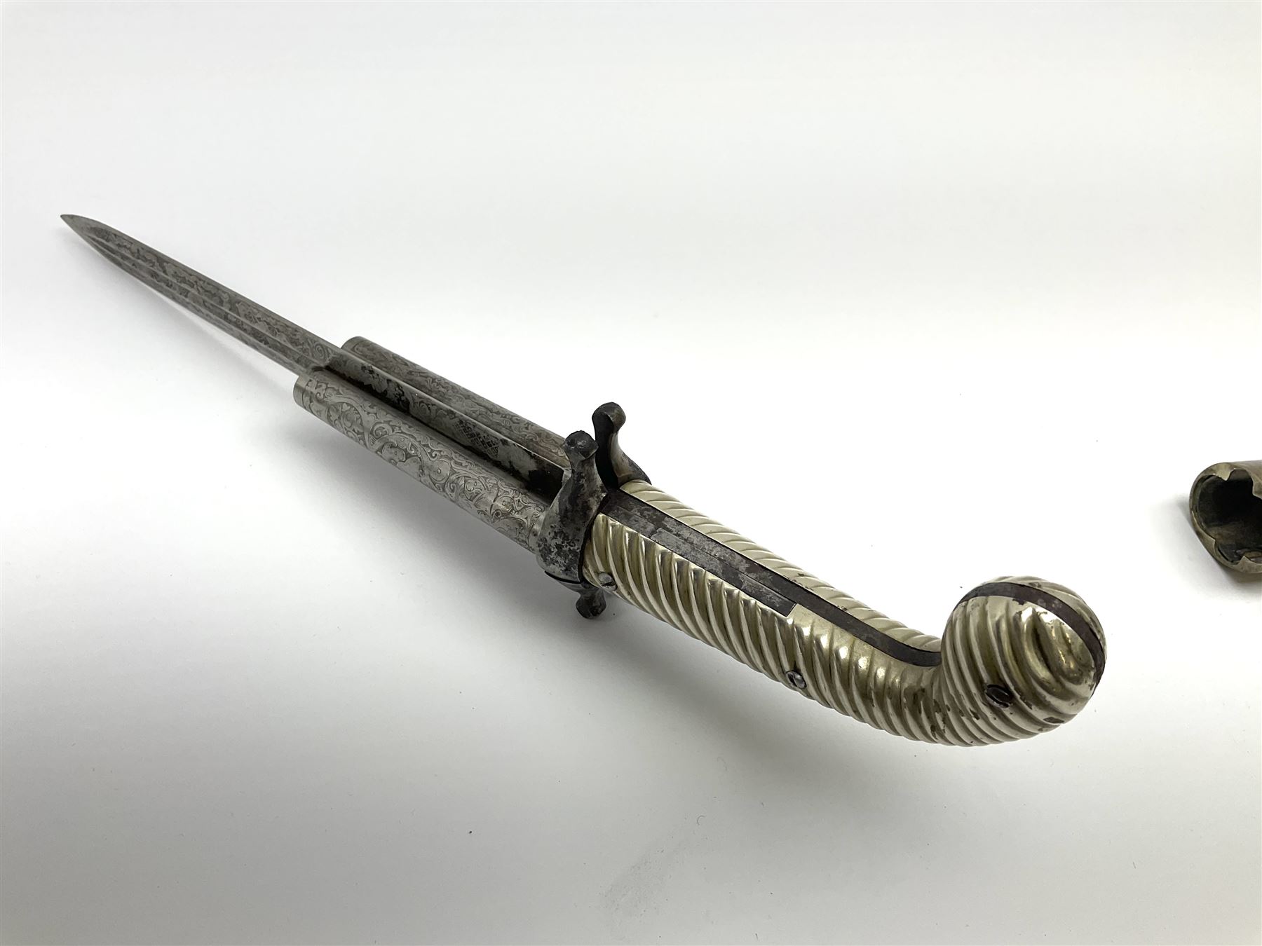 Rare double barrel percussion knife pistol by Dumonthier & Sons (NVN), approx. .38 calibre, with 8.5cm barrels and central 21.5cm spear pointed blade, all with etched damascening, upper quillons serve as hammers for the percussion ignition with single drop down trigger and fluted nickel grips, in nickel mounted leather covered tin scabbard L33.5cm overall