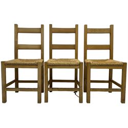 Set of six beech framed farmhouse design dining chairs, with rush seats, on square supports united by plain stretchers 