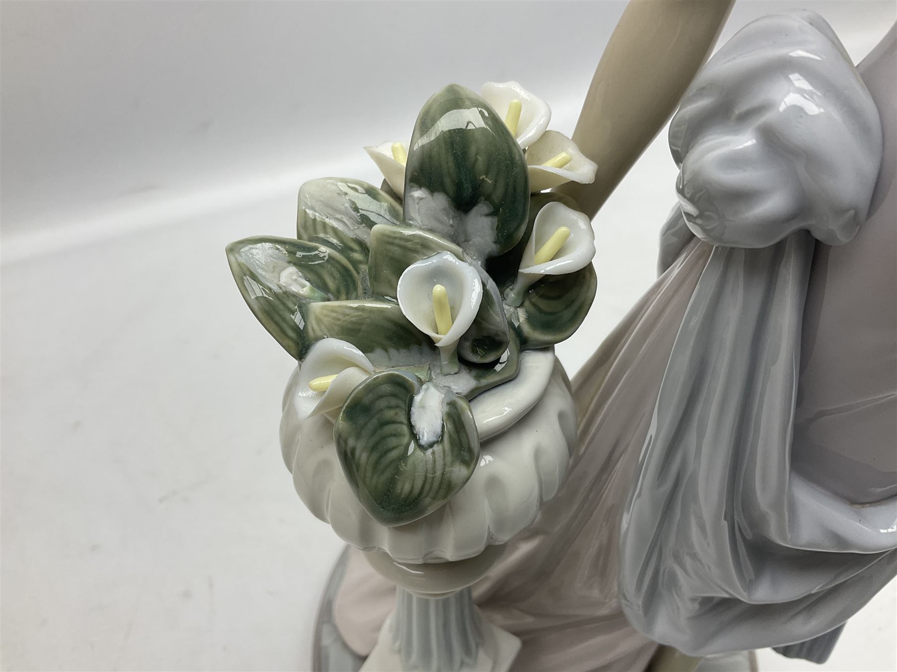 Four Lladro figures, comprising Touch of Class no 5377, Boy Student no 4517, Ocean Beauty no 5785 and Carnival Couple no 4882, largest example H45cm