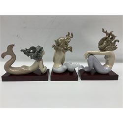 Lladro Mermaid trio set, comprising Illusion no. 1413, Fantasy no.1414 and Mirage no. 1415, all with wooden bases, largest H20cm