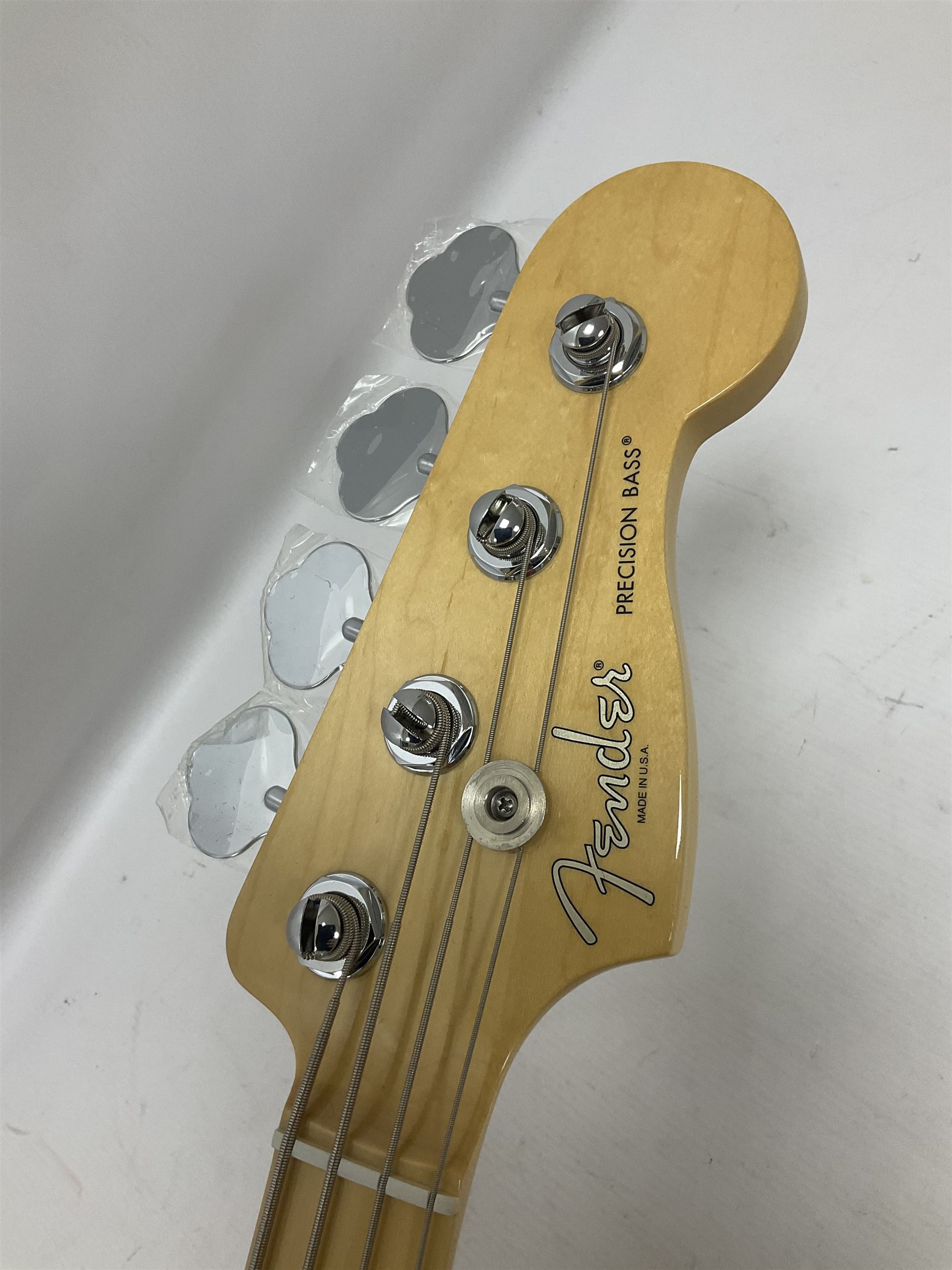 Fender Precision Bass guitar, in Olympic White finish with tortoiseshell effect scratchboard, serial no US15103092, in black Fender hard case with Fender strap and warranty card, guitar L116cm