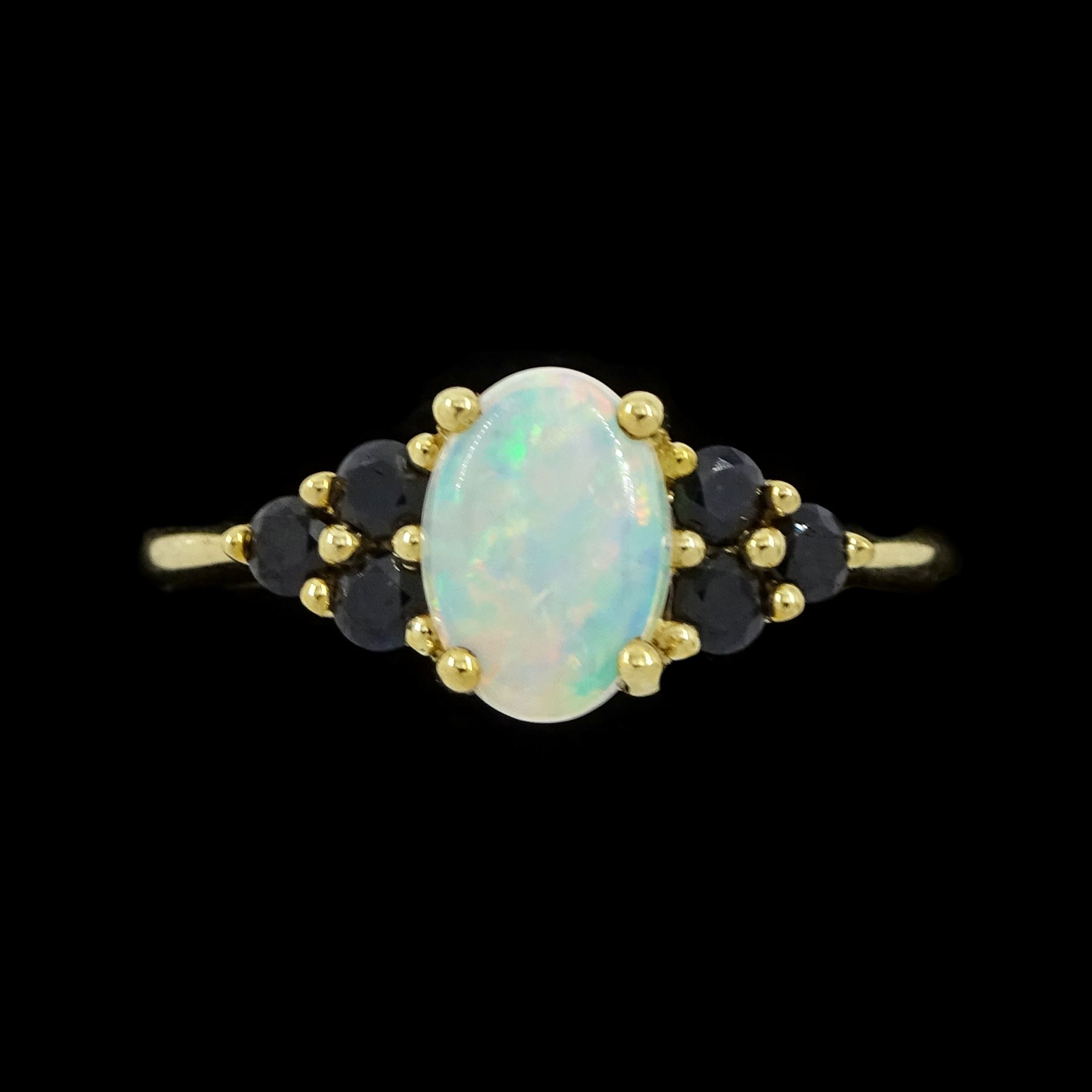 9ct gold opal and sapphire ring, single oval cut opal, with three sapphires set either side, hallmarked