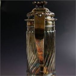 George I silver-gilt wine flagon, of tapering cylindrical form with part fluted body and upon circular spreading foot, with c-scroll handle, domed lid with rose to centre  and scroll thumb piece, hallmarked London 1725, maker's mark indistinct, with later refinements, the original hallmarks struck-through and re-assayed by the London Assay 2021, H33cm