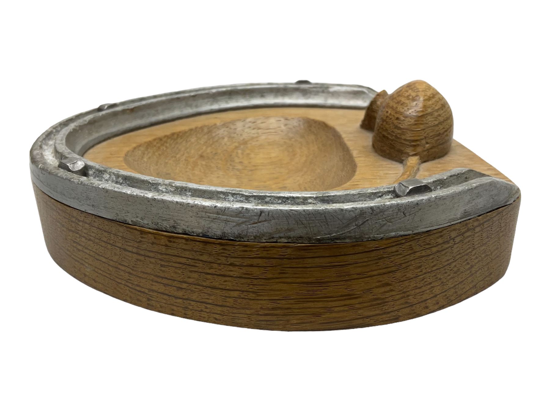 Mouseman - oak horseshoe ashtray, rounded triangular form with mounted horseshoe, carved with mouse signature, by the workshop of Robert Thompson, Kilburn, L13cm