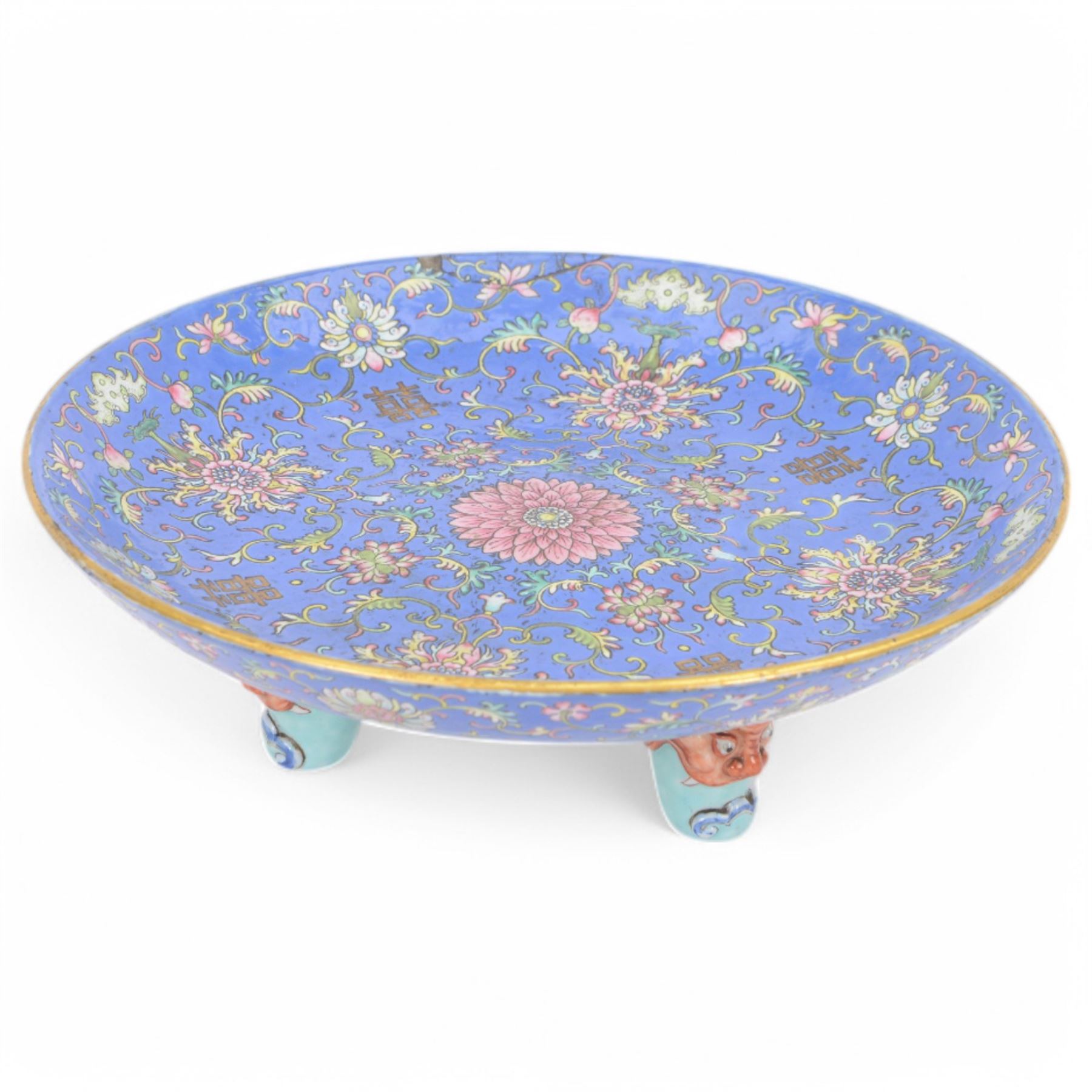 20th century Chinese footed bowl, of circular form, decorated in polychrome enamels with flowers and foliage on a cobalt blue ground, upon three grotesque mounted feet, with character marks beneath, H13cm, D38cm