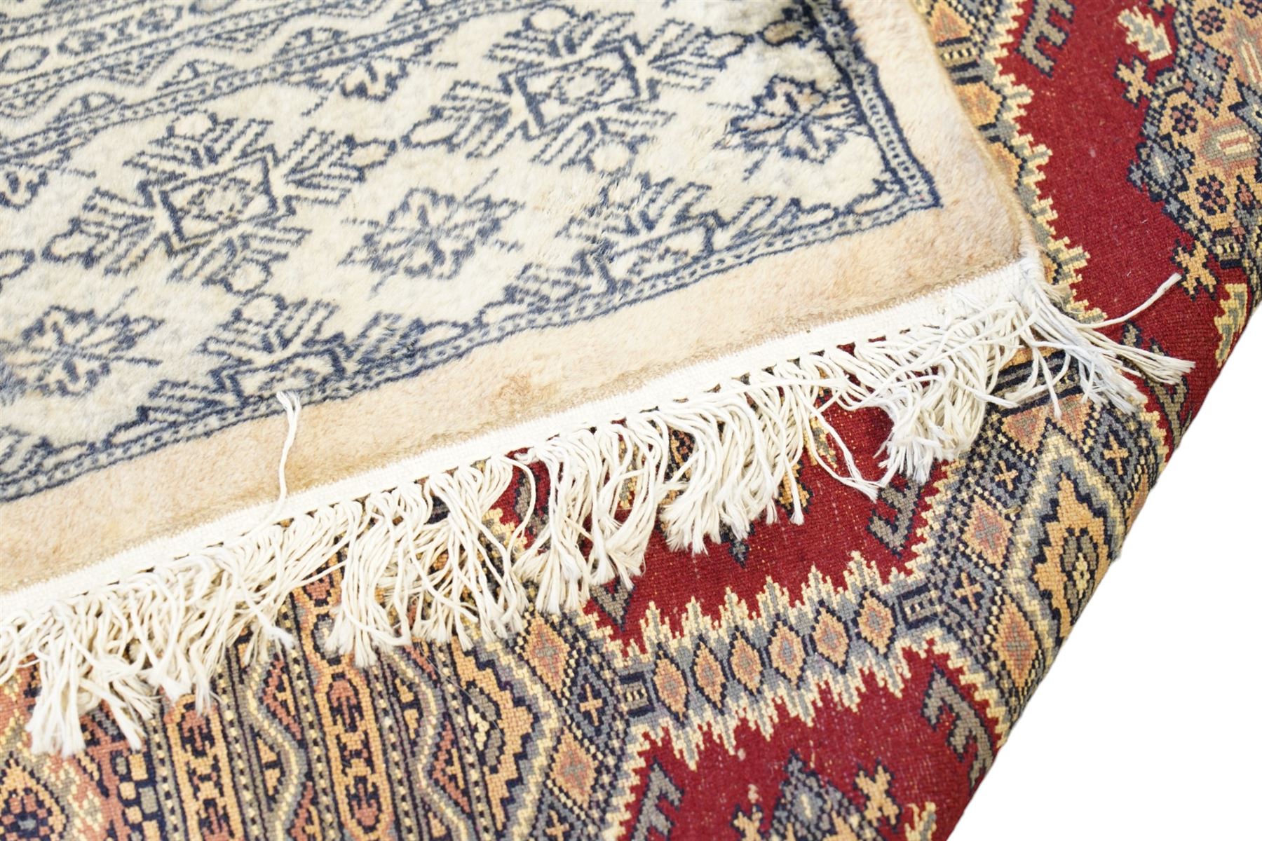 Jaldar Bokhara crimson and pale ground carpet, the field decorated with five rows of Gul motifs, within intricate multi-band border decorated with repeating geometric designs 