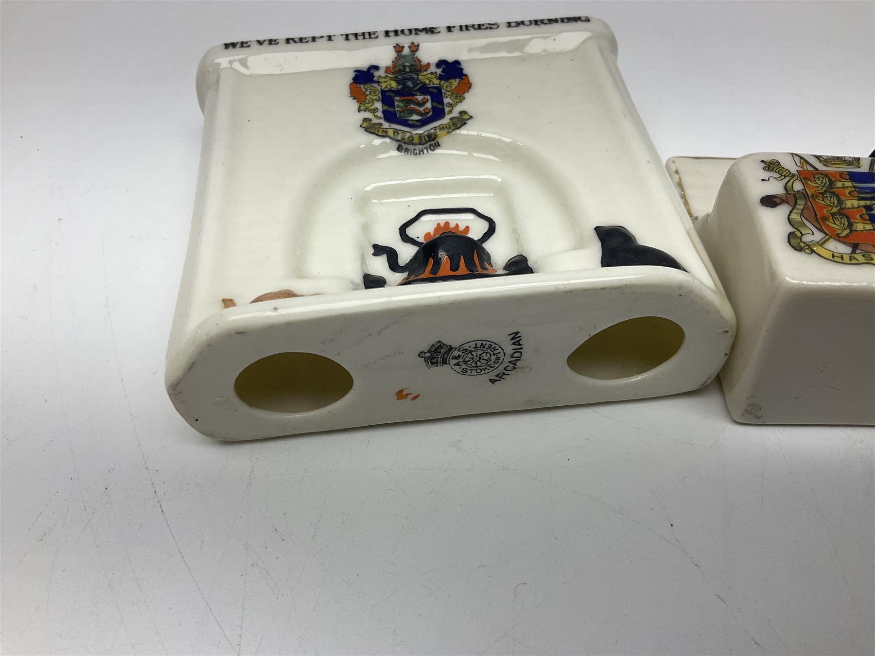 Ten WW1 crested china military models comprising seven field ambulances and three 'Home Fires Burning' fire-surrounds/range; various makers including Willow Art, Arcadian China, Grafton China, Savoy China, Carlton China etc; various crests including Devon, Aldershot, Portsmouth, West Ham, Coventry, Oxford, Hastings, Brighton etc (10)