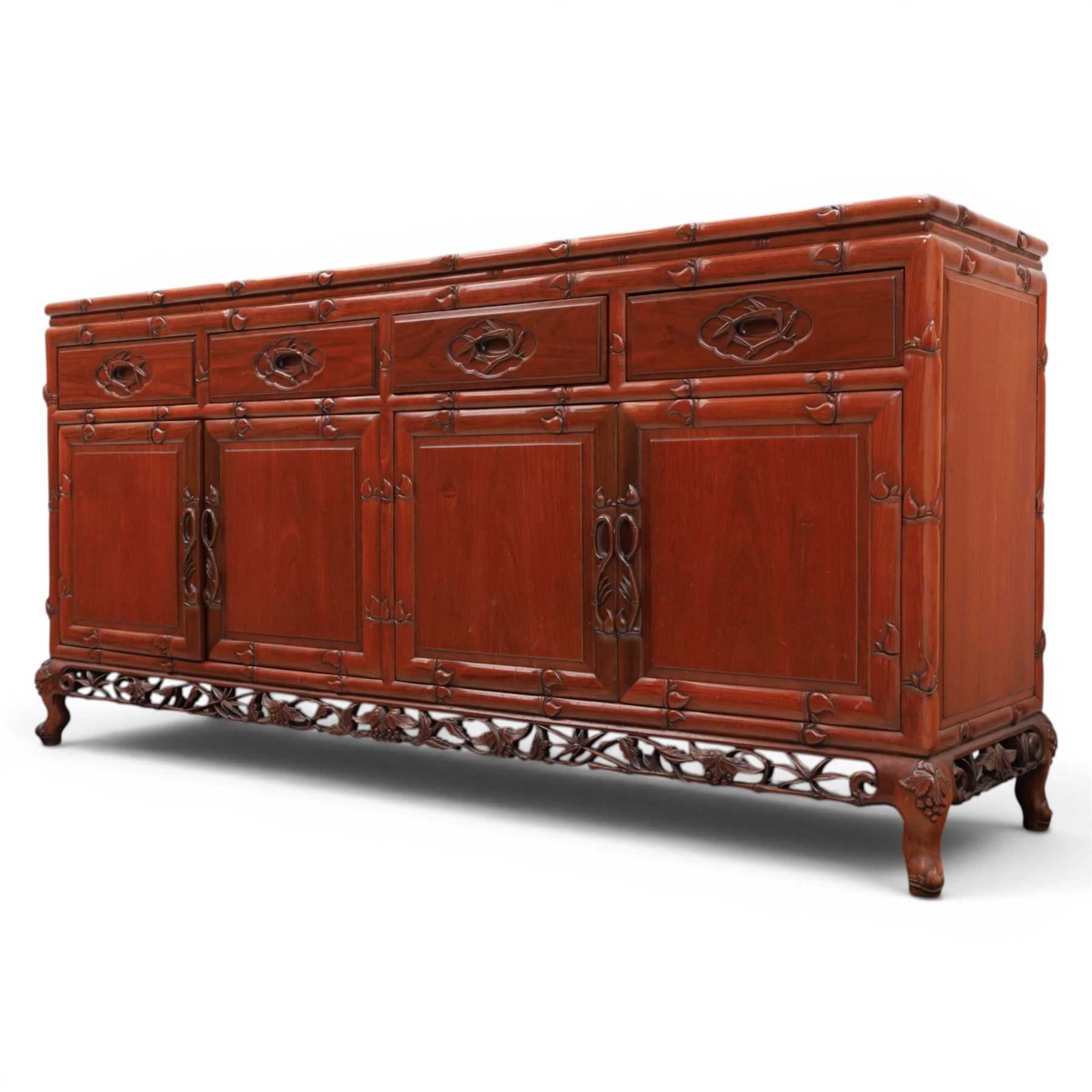 20th century Chinese ornately hardwood sideboard, rectangular top over four drawers above four cupboards, pierced carved apron, raised on cabriole legs 