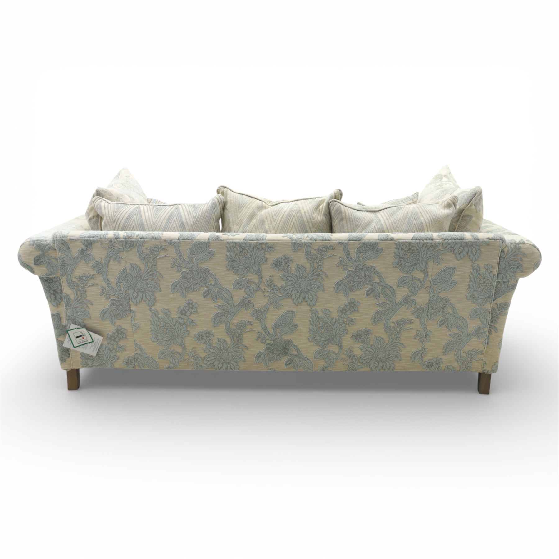 Alstons - 'Lowry' three seater settee, loose cushioned back and seat with additional cushions upholstered in silver and blue floral fabric, supported on square feet with chrome castors to the front