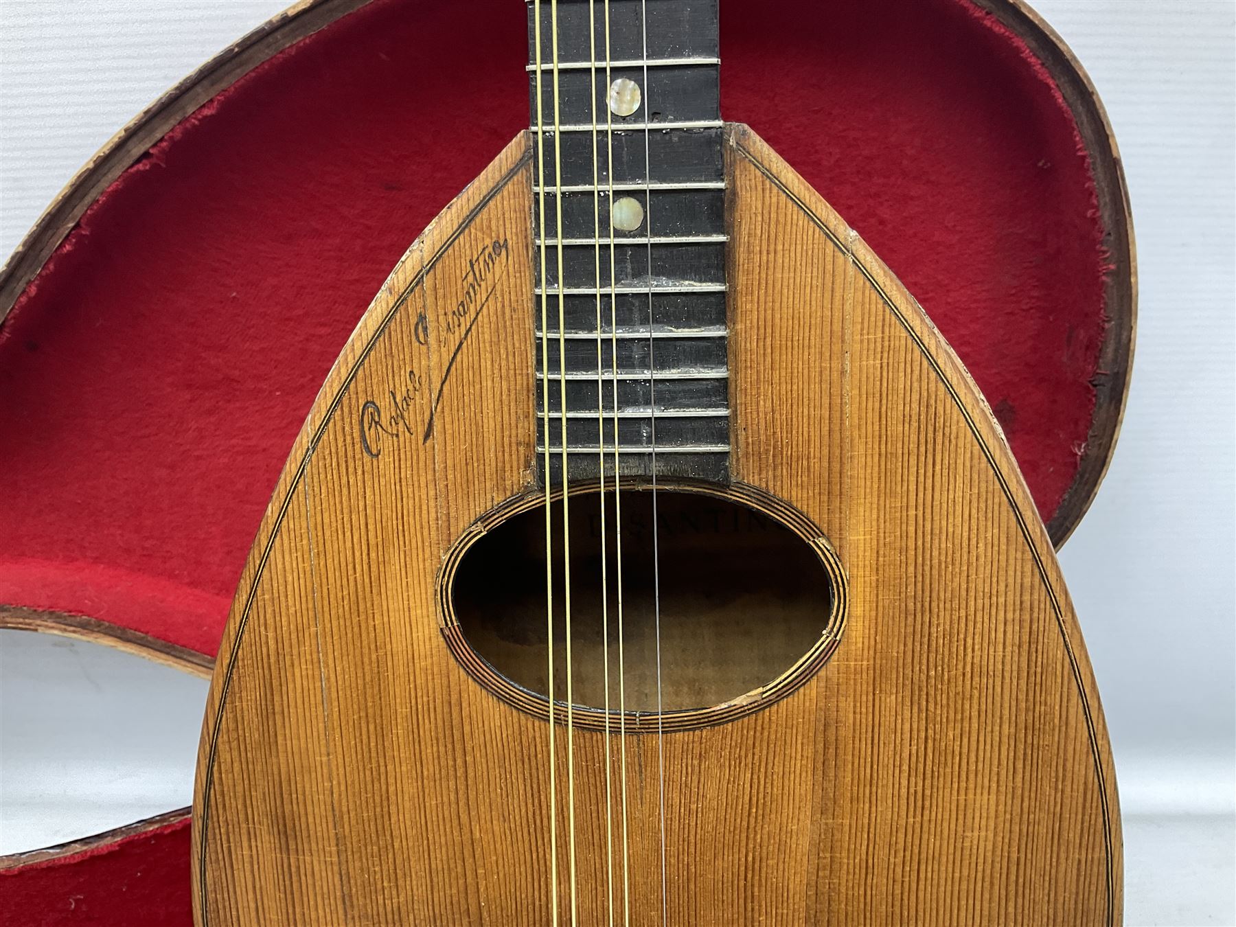 Early 20th century Italian Rafaele Disantino eight-string mandolin with two-piece back and spruce top with stamped Rafaele Disantino signature; bears maker's label L61cm; in wooden carrying case