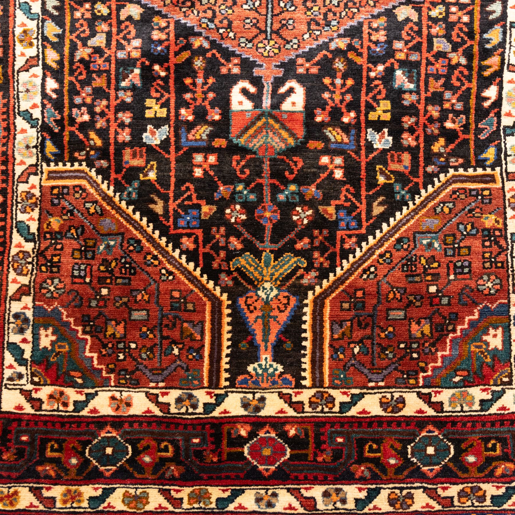 North West Persian Koliahee hand-knotted runner, indigo field with three large linked lozenge medallions in a madder red, framed by angular floral motifs and stylized vines within ivory and terracotta geometric borders, fringe ends  