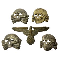 Five German 'SS' visor cap metal badges comprising one eagle and four skull and cross-bones (5)