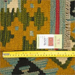 Afghan Maimana flatweave kilim, central field features large bold nested diamond motifs and stylized geometric lozenge patterns on olive purple, blue, and green tone ground, dark green border stripe, with fringe ends