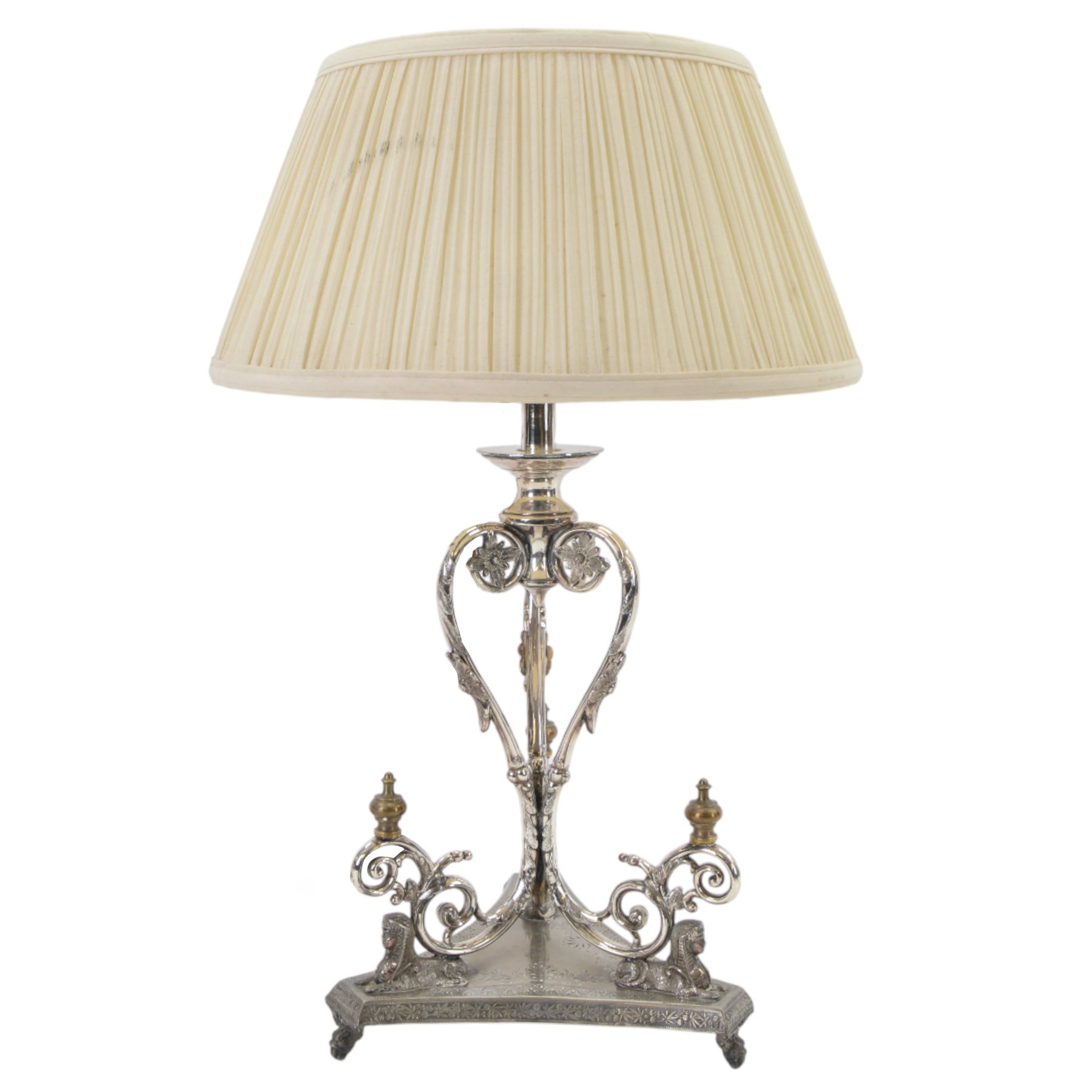 Silver plated Egyptian Revival lamp, with scrolling columns, on a trefoil base, surmounted by three sphinxes, with mask feet, H60cm